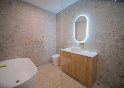 A Bathroom With a Bathtub, Sink, Toilet and Mirror — Darko's Kitchens in Blackbutt, Queensland