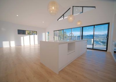 An Empty Kitchen With a Large Island in the Middle of the Room — Darko's Kitchens in Blackbutt, Queensland