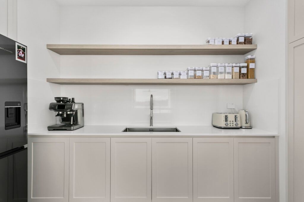 A Kitchen With a Sink , Refrigerator , and Shelves — Darko's Kitchens in Primbee, NSW