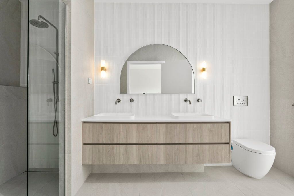 A Bathroom With Two Sinks, a Toilet and a Shower — Darko's Kitchens in Primbee, NSW