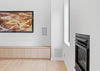 A Living Room With a Fireplace and a Flat Screen Tv on the Wall — Darko's Kitchens in Woonona, NSW