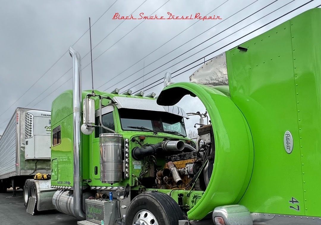 A bright green semi-truck with its hood tilted forward, exposing the engine, parked with a trailer on a cloudy day.