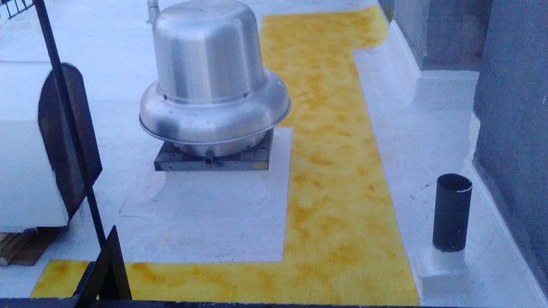 there is a fan on the roof of a building .