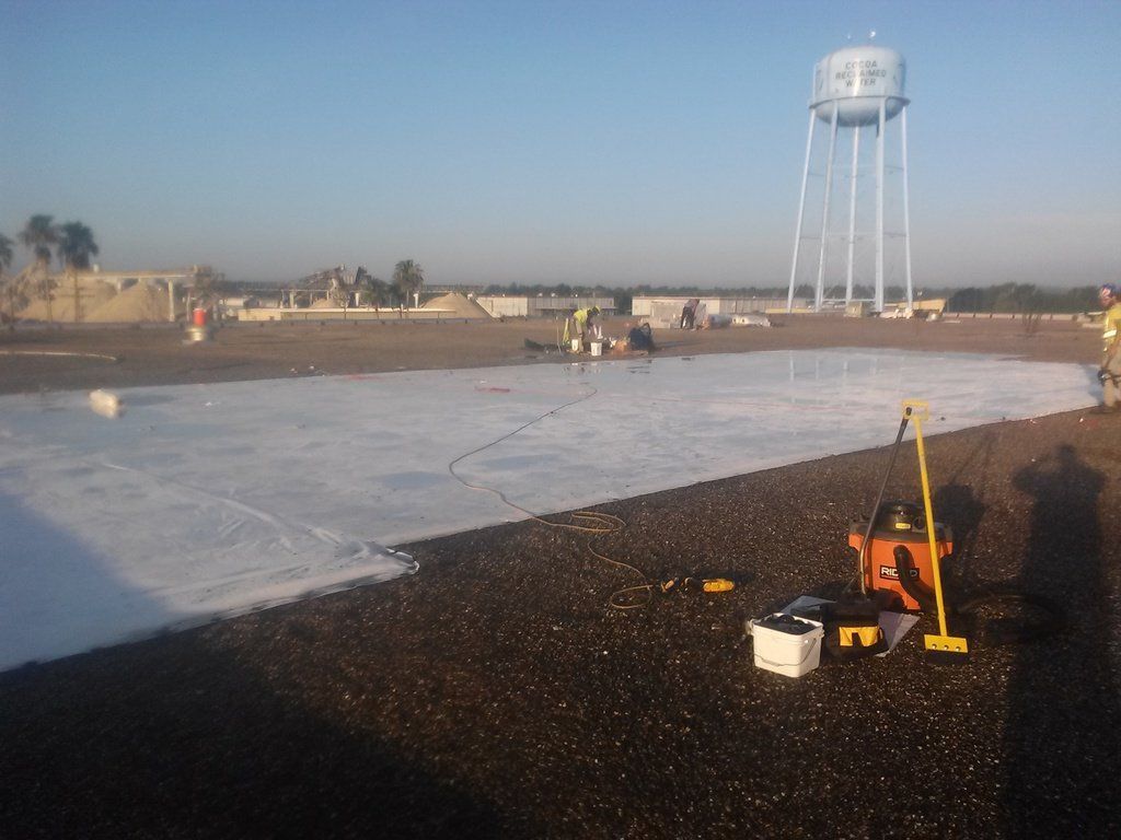 a water tower is in the background of a construction site