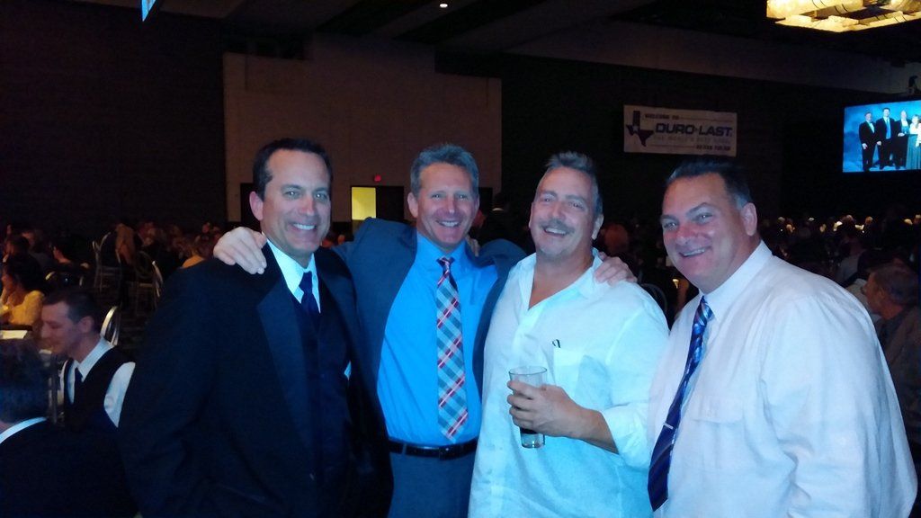 a group of men posing for a picture in a dark room
