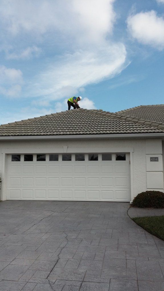 a man is standing on the roof of a house .