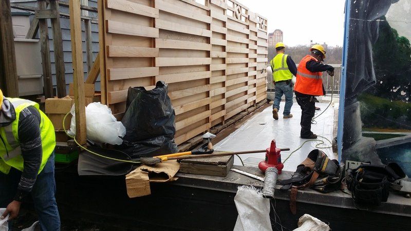 Roofing contractors working on roof