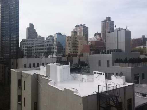 a city skyline with a white building in the foreground