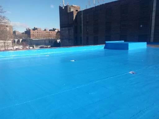 a blue roof with a view of a city in the background .