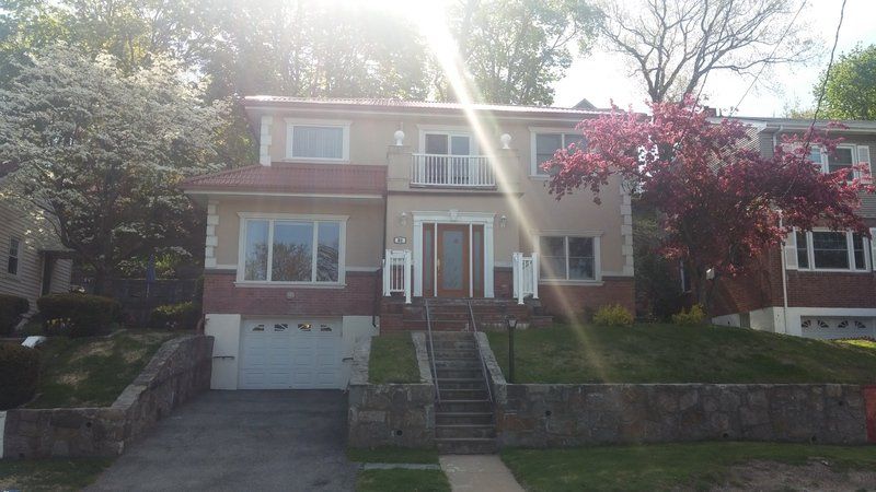 a large house with a lot of windows and a tree in front of it .