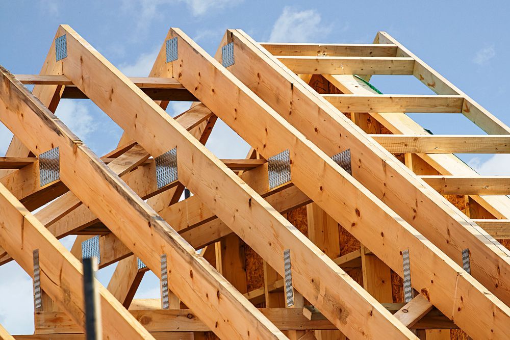 Wooden Roof Trusses Against a Blue Sky — Boyne Building & Renovations in Wellington, NSW