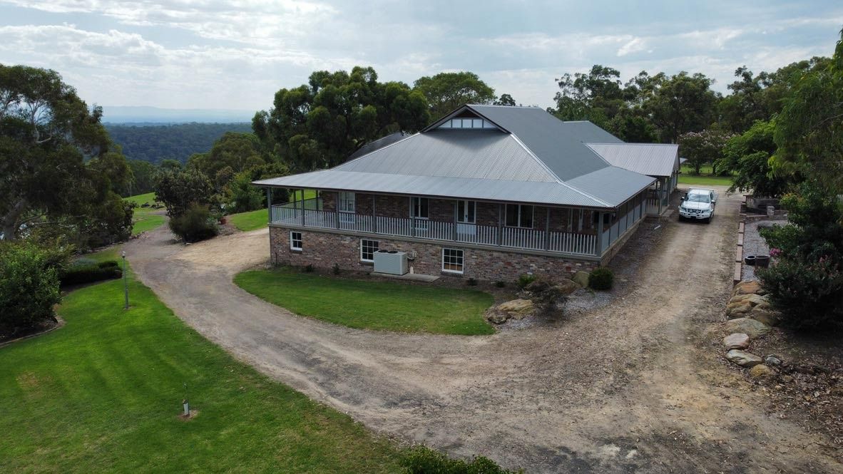 House With Wrap-around Porch and Stone Exterior — Boyne Building & Renovations in Ponto, NSW