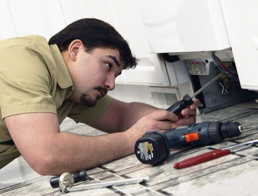 Man working on an appliance service in Auckland and the North Shore