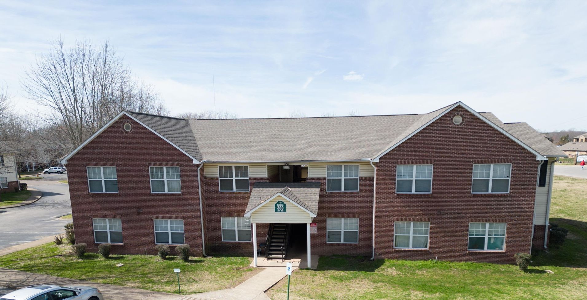 An aerial view of a large brick apartment building with a lot of windows.