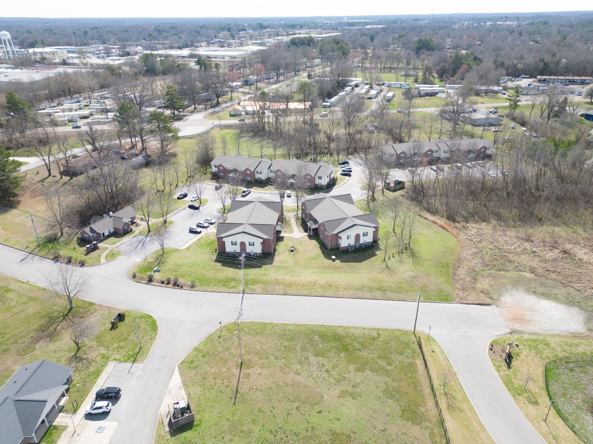 An aerial view of a residential area with a lot of houses and trees.