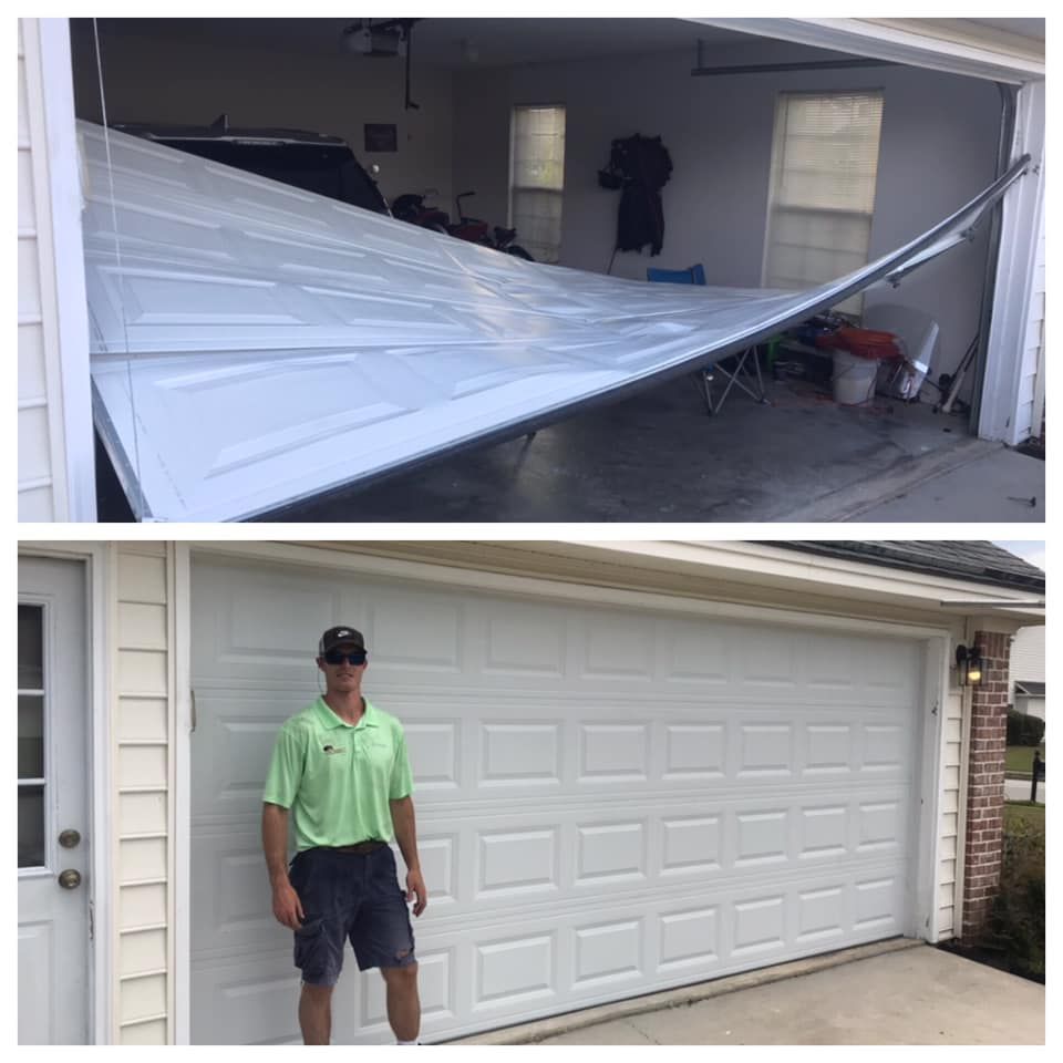 A man is standing in front of a garage door that has been damaged.