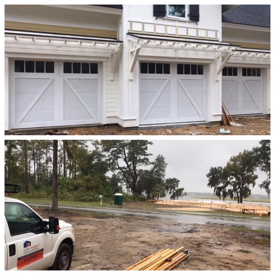 A white truck is parked in front of a white house