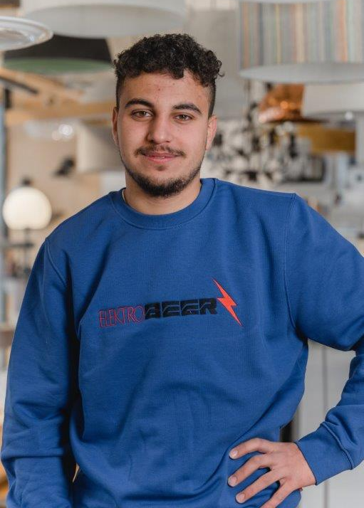 Ein Mann trägt ein blaues Sweatshirt mit dem Wort „Bier“ darauf