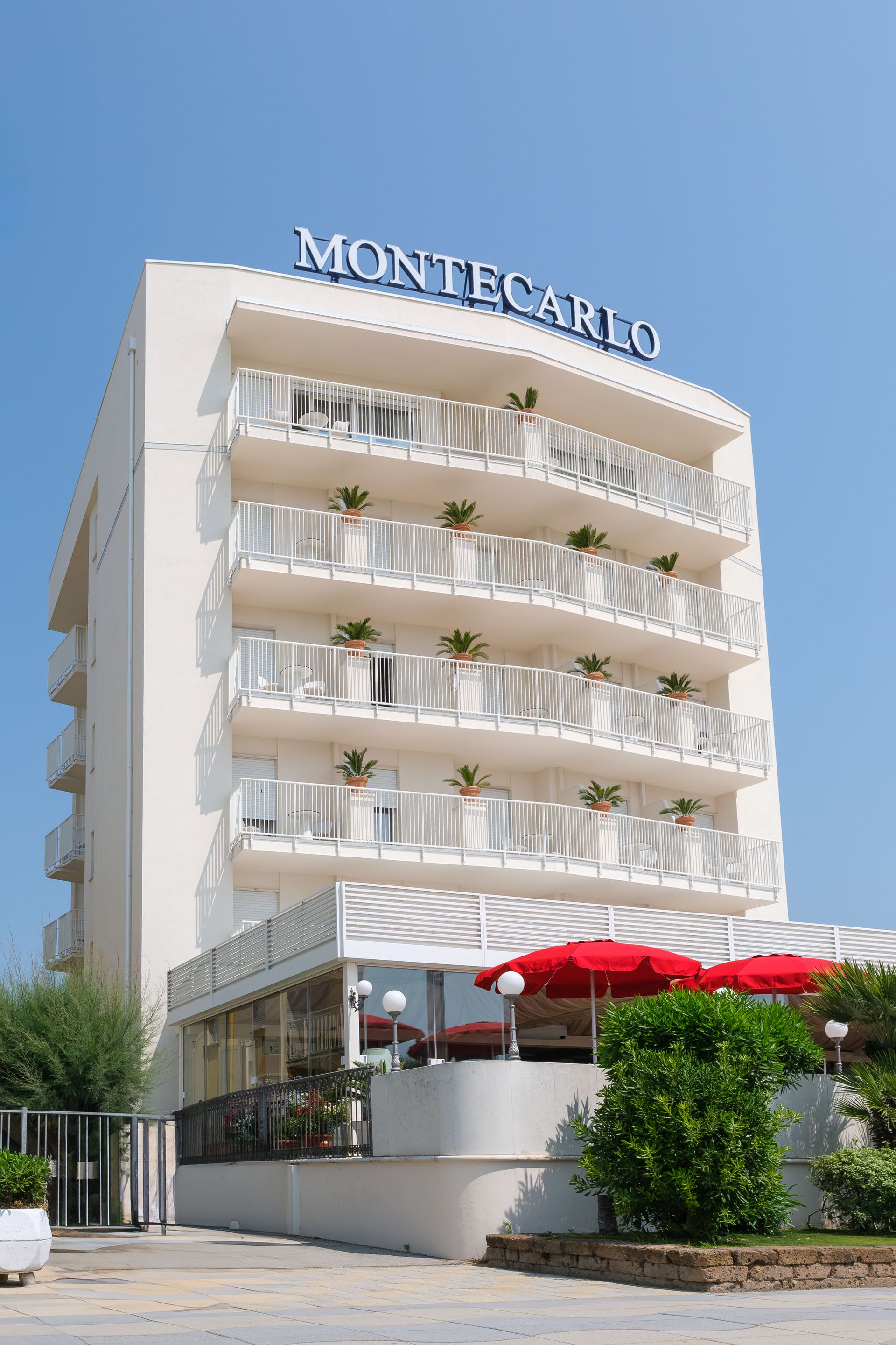 A white building with the word Montecarlo on top of it.