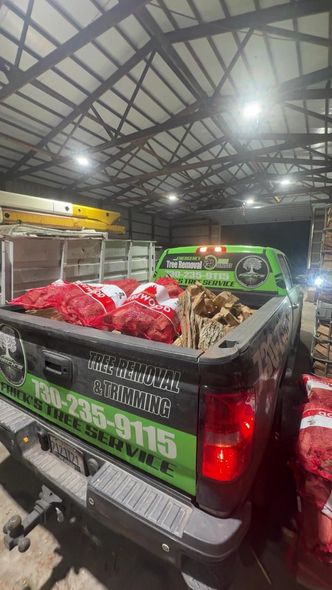 Pickup truck loaded with red produce sacks inside a covered market or warehouse