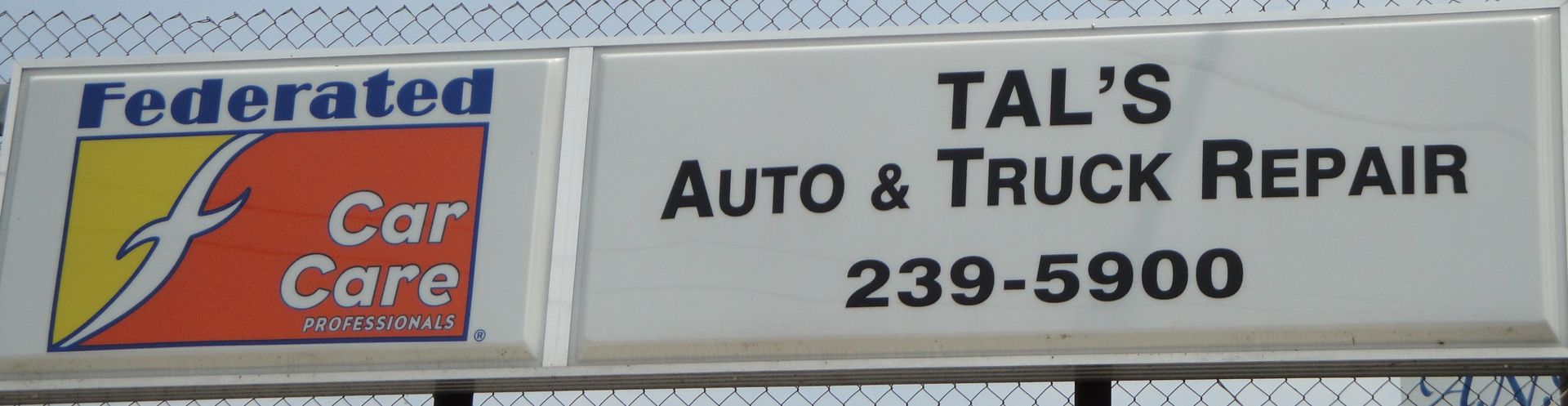 A sign for tal 's auto and truck repair