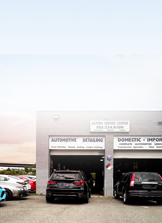 A car dealership with cars parked in front of it. | Action Service Center