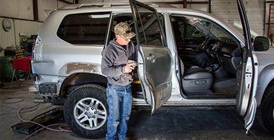 Car Wreck Repair — Man Fixing Car Door in Montrose, CO