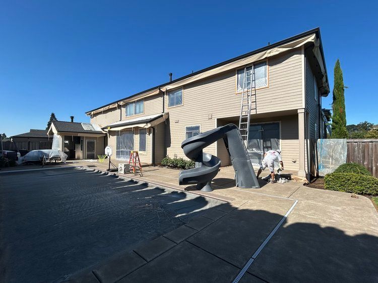 A large house with a slide in front of it