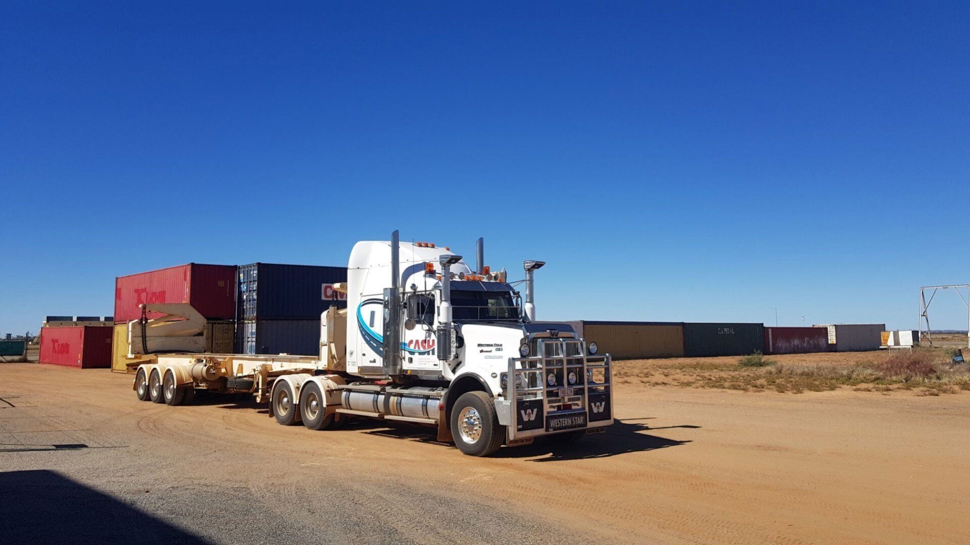 White Western Star Semi-Truck on A Dirt Road — Central Australian Sidelifter Haulage in Ciccone, NT