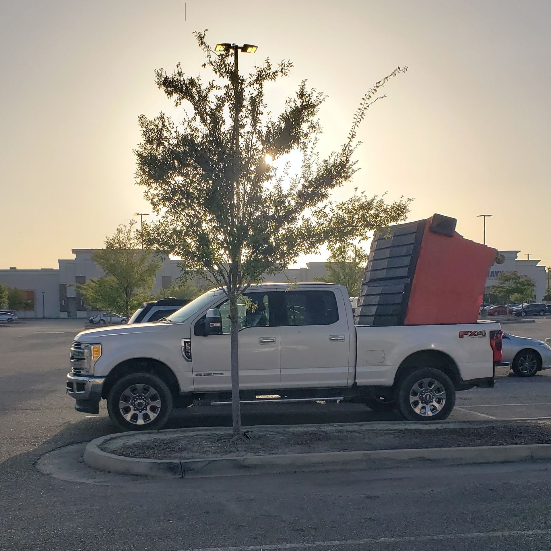 A white pickup truck is parked in a parking lot