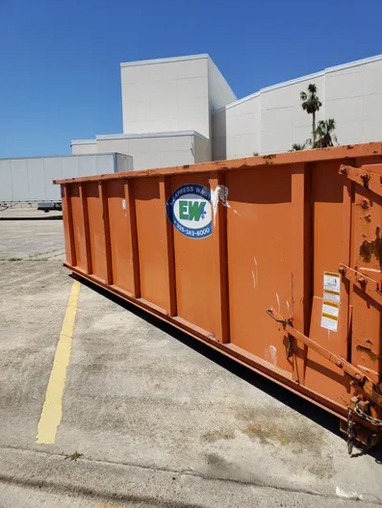 A large orange dumpster with the word emc on it