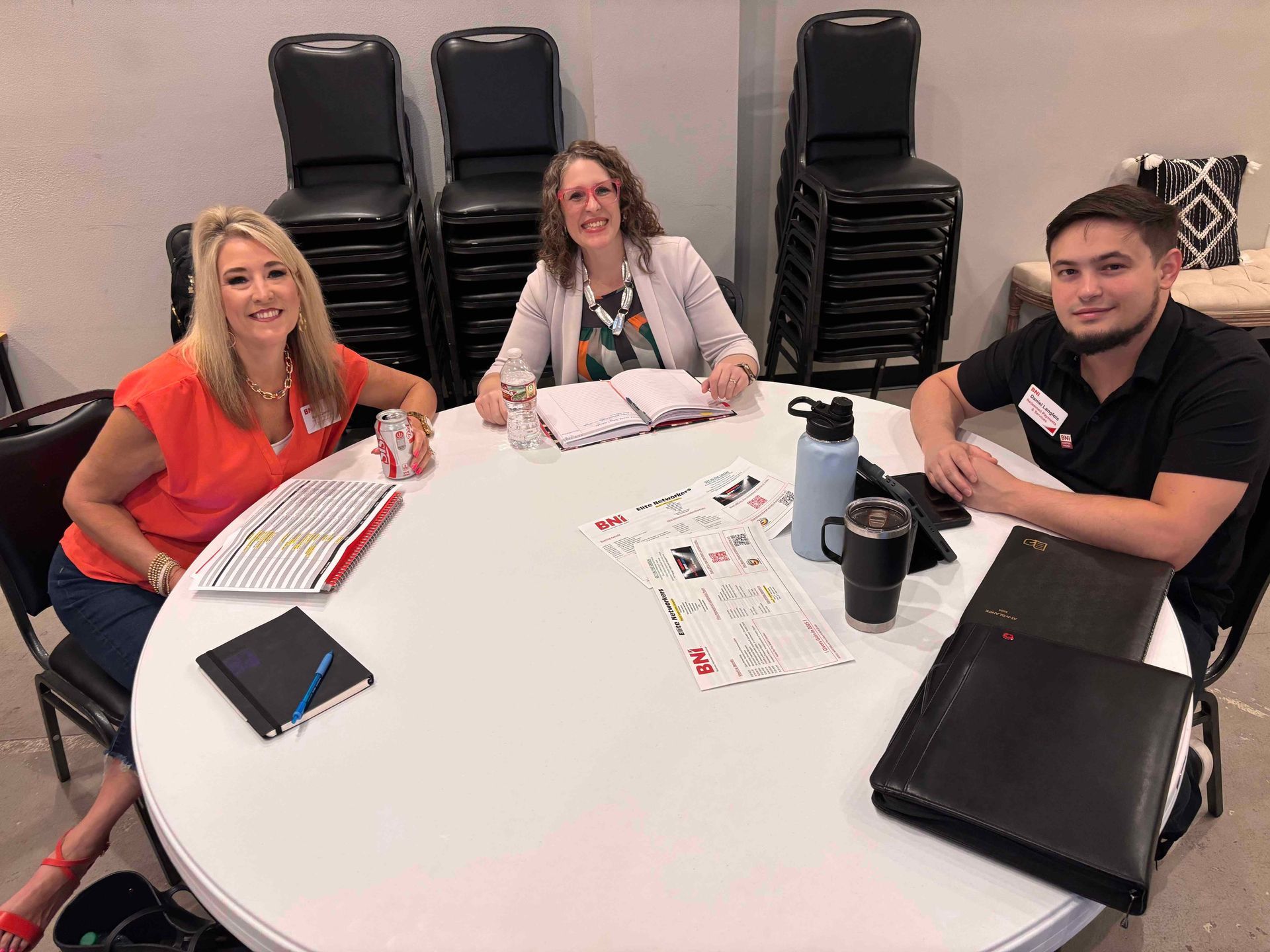 A group of people are sitting around a round table.