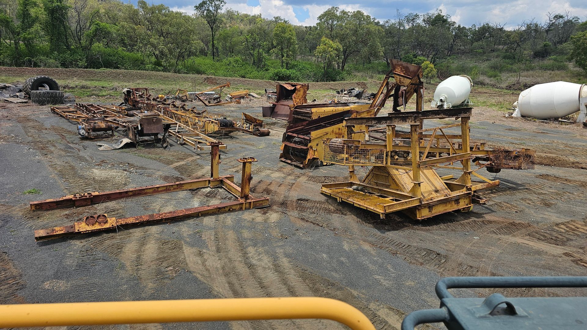 Orange Hitachi Excavator on a Flatbed Trailer Under a Blue Sky, in a Construction Site — NPX Solutions In Rockhampton City, QLD