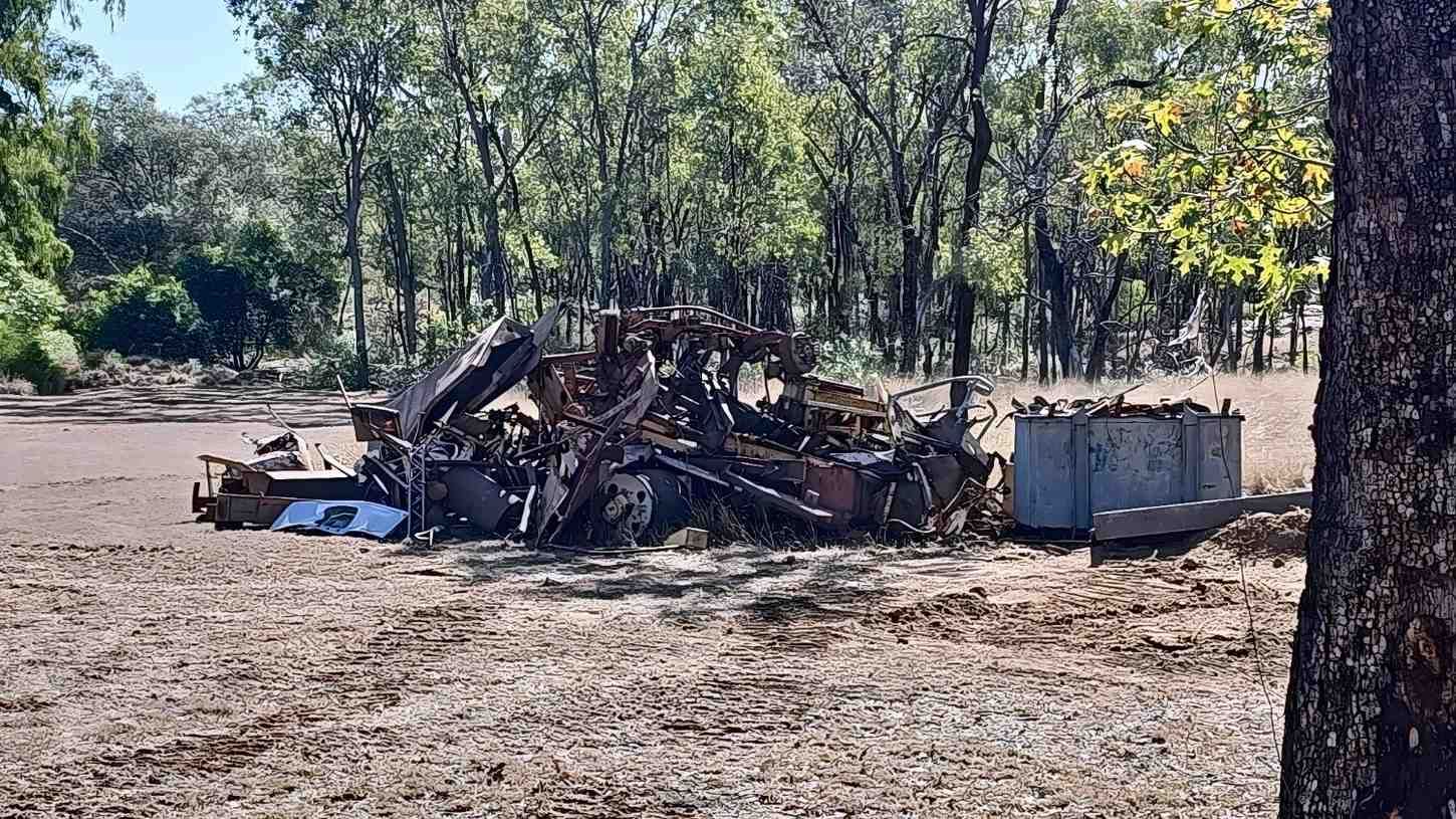 Burnt Out Vehicle Wreckage in a Dry, Outdoor Setting — NPX Solutions In Rockhampton City, QLD