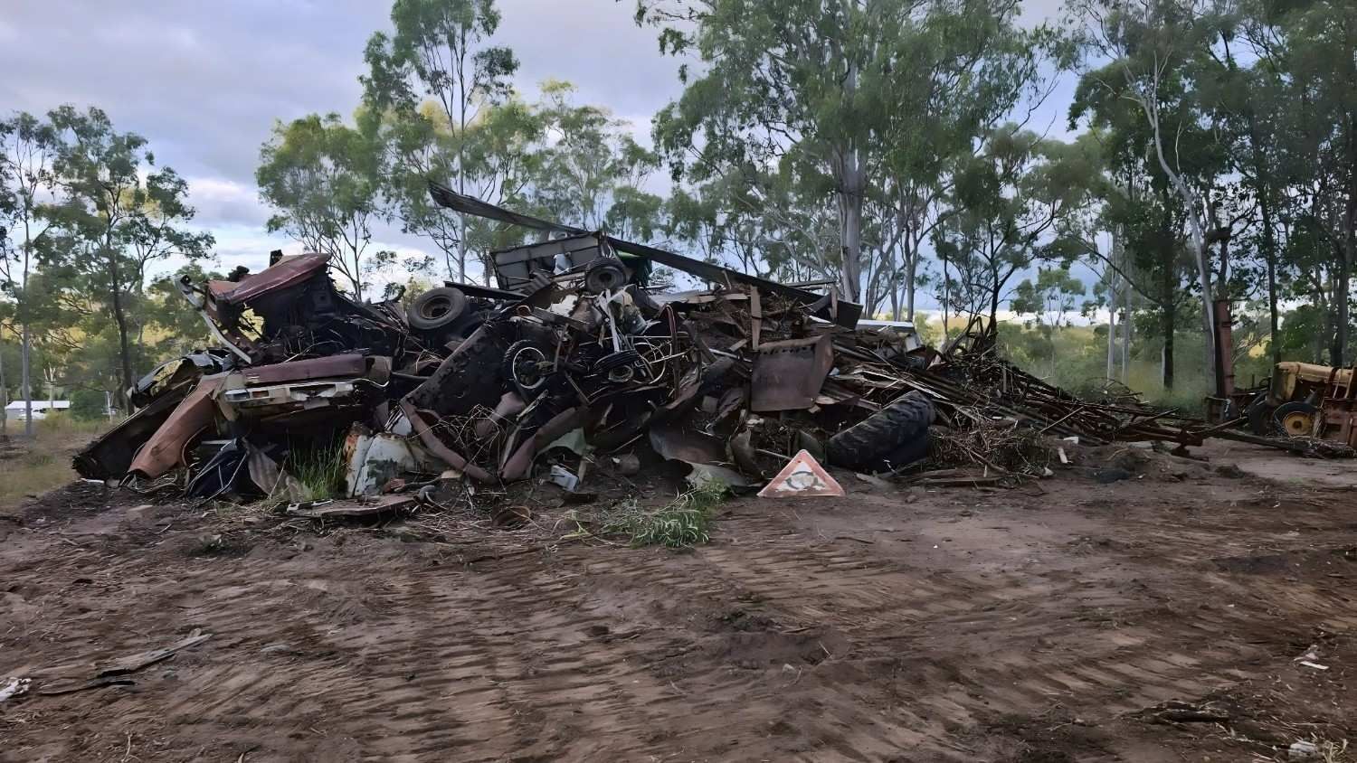 Heap of Scrap Metal and Debris Outdoors, Trees in the Background — NPX Solutions In Moranbah, QLD