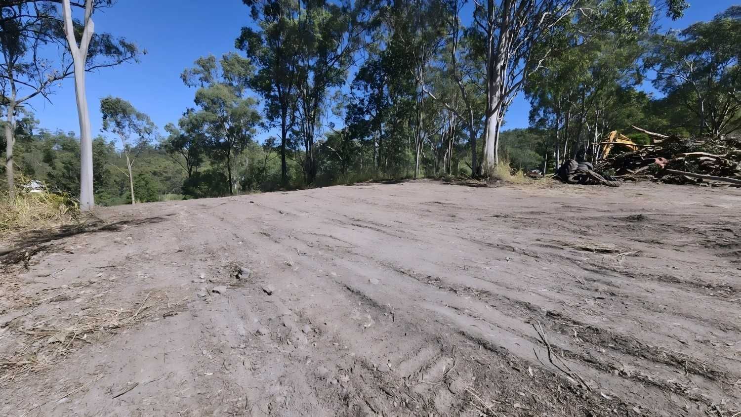 Dirt Road Through a Wooded Area on a Sunny Day. Trees Line the Road — NPX Solutions In Moranbah, QLD