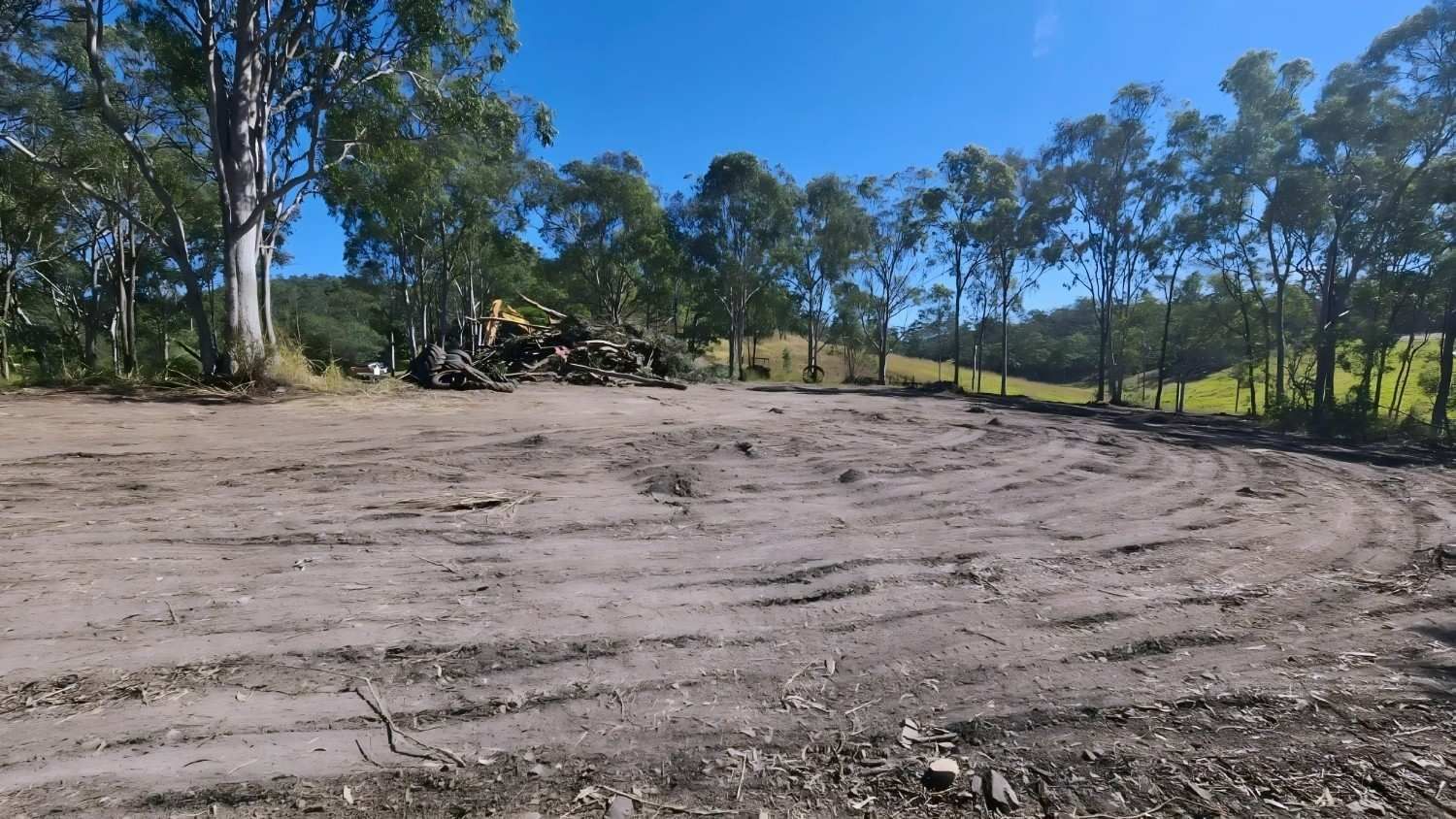 Dirt Clearing With Trees in the Background Under a Blue Sky — NPX Solutions In Middlemount, QLD