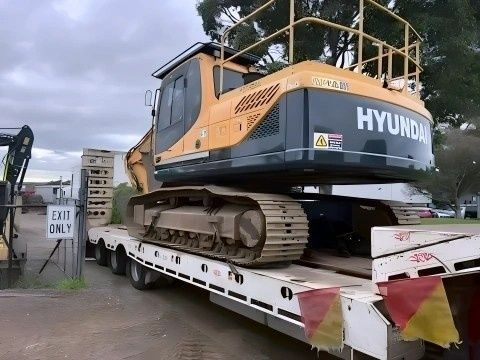 Yellow Hyundai Excavator on a Flatbed Trailer, Ready for Transport — NPX Solutions In Middlemount, QLD