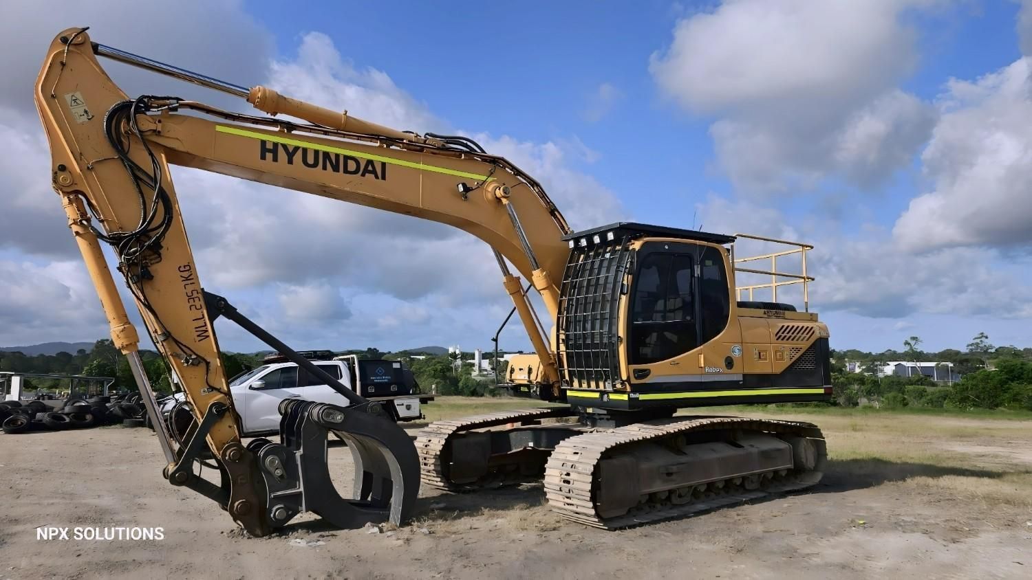 Yellow Hyundai Excavator With Black Grapple Attachment — NPX Solutions In Moranbah, QLD