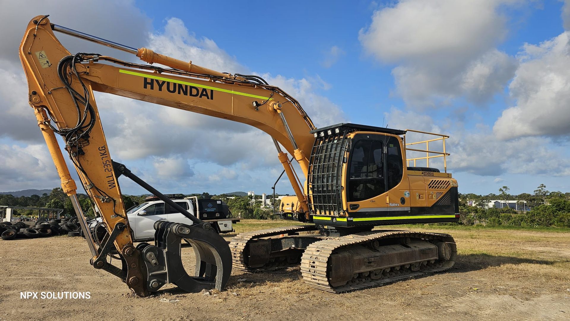 Yellow Hyundai Excavator With a Grapple Attachment — NPX Solutions In Rockhampton City, QLD