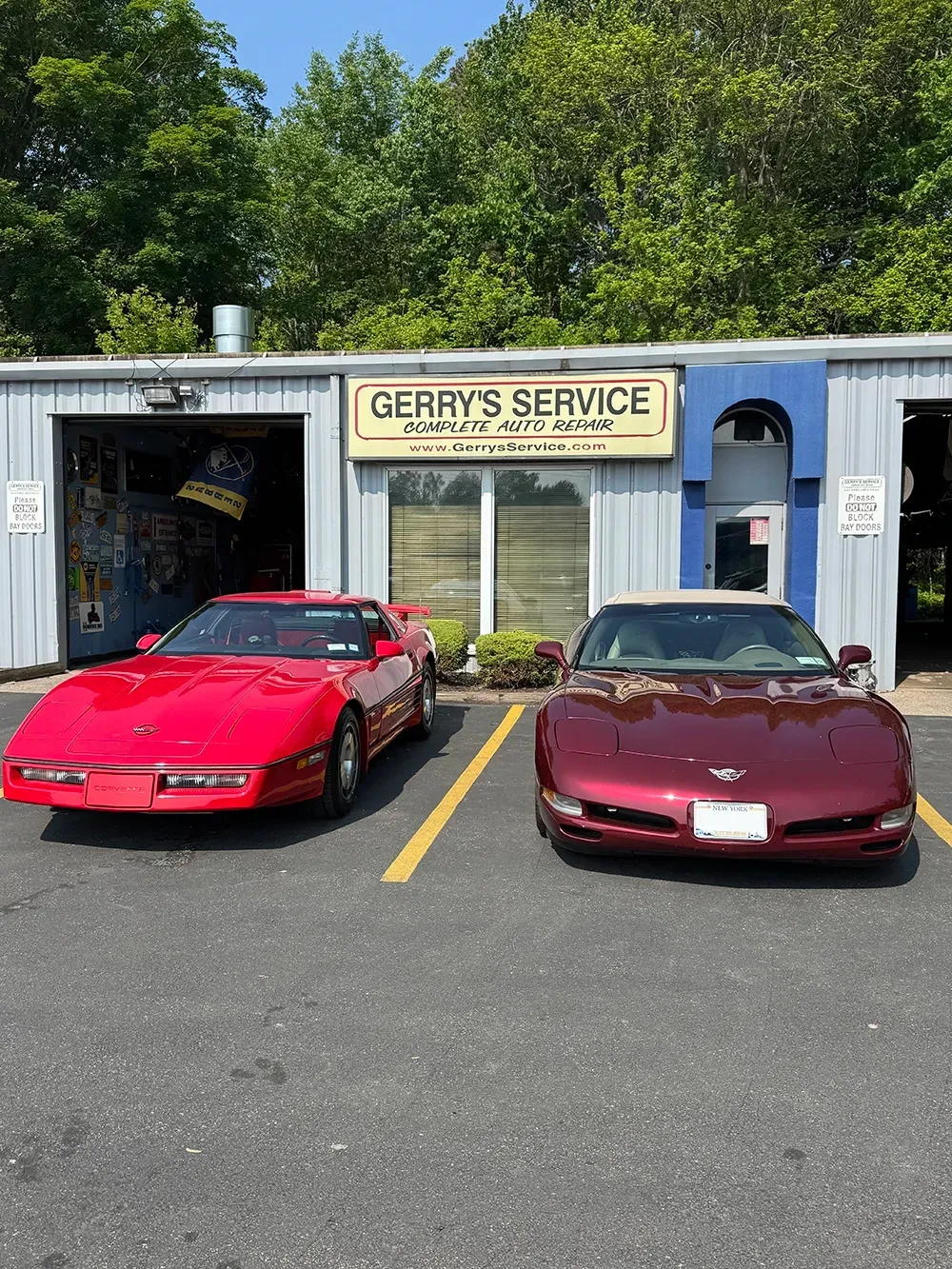 Two red classic cars in parking lot | Gerry's Service