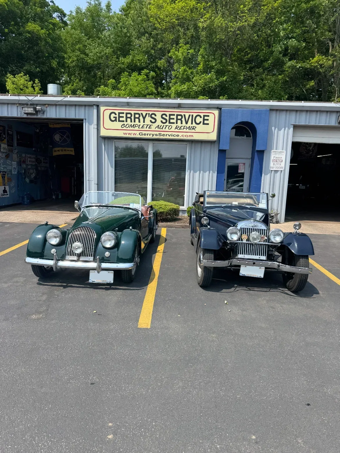 Two classic cars parked in front of our shop | Gerry's Service