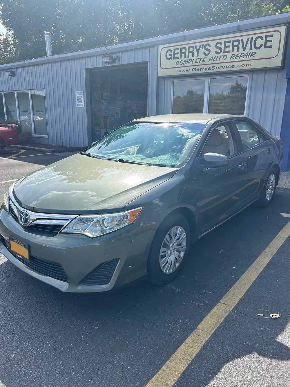 Gray car parked in our parking lot in front of our shop | Gerry's Service