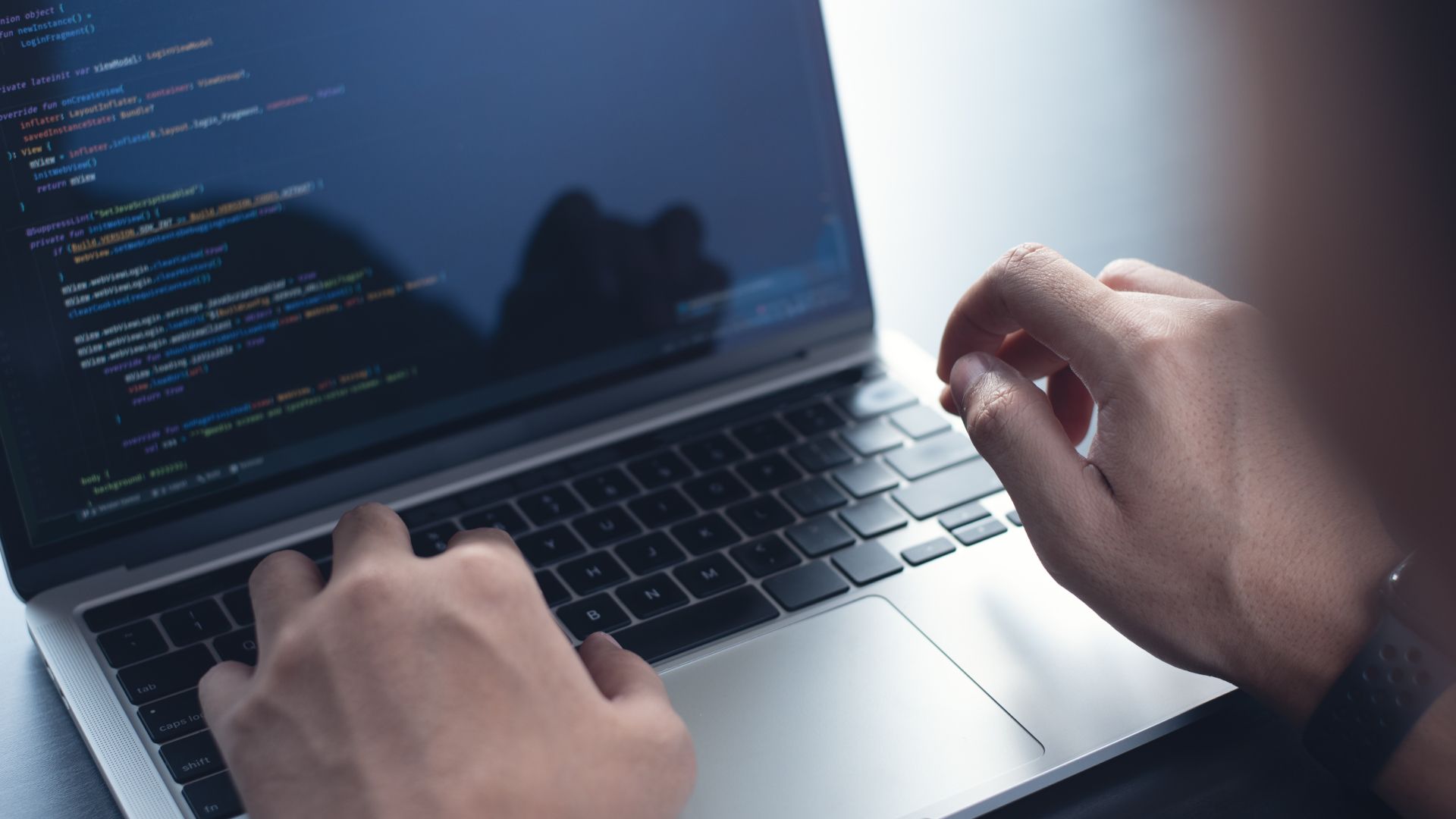 A person is typing on a laptop computer.