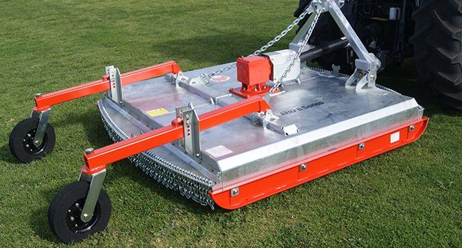 Agricultural Tractor Mowing New Grass On The Field — O'Brien's Machinery In Hunter Valley NSW
