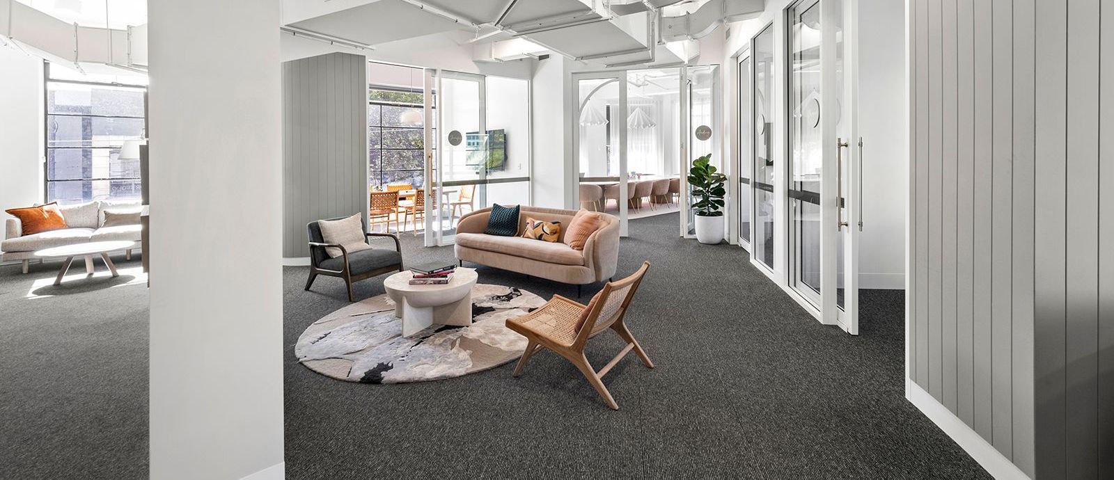 A living room with a couch , chairs , and a coffee table.