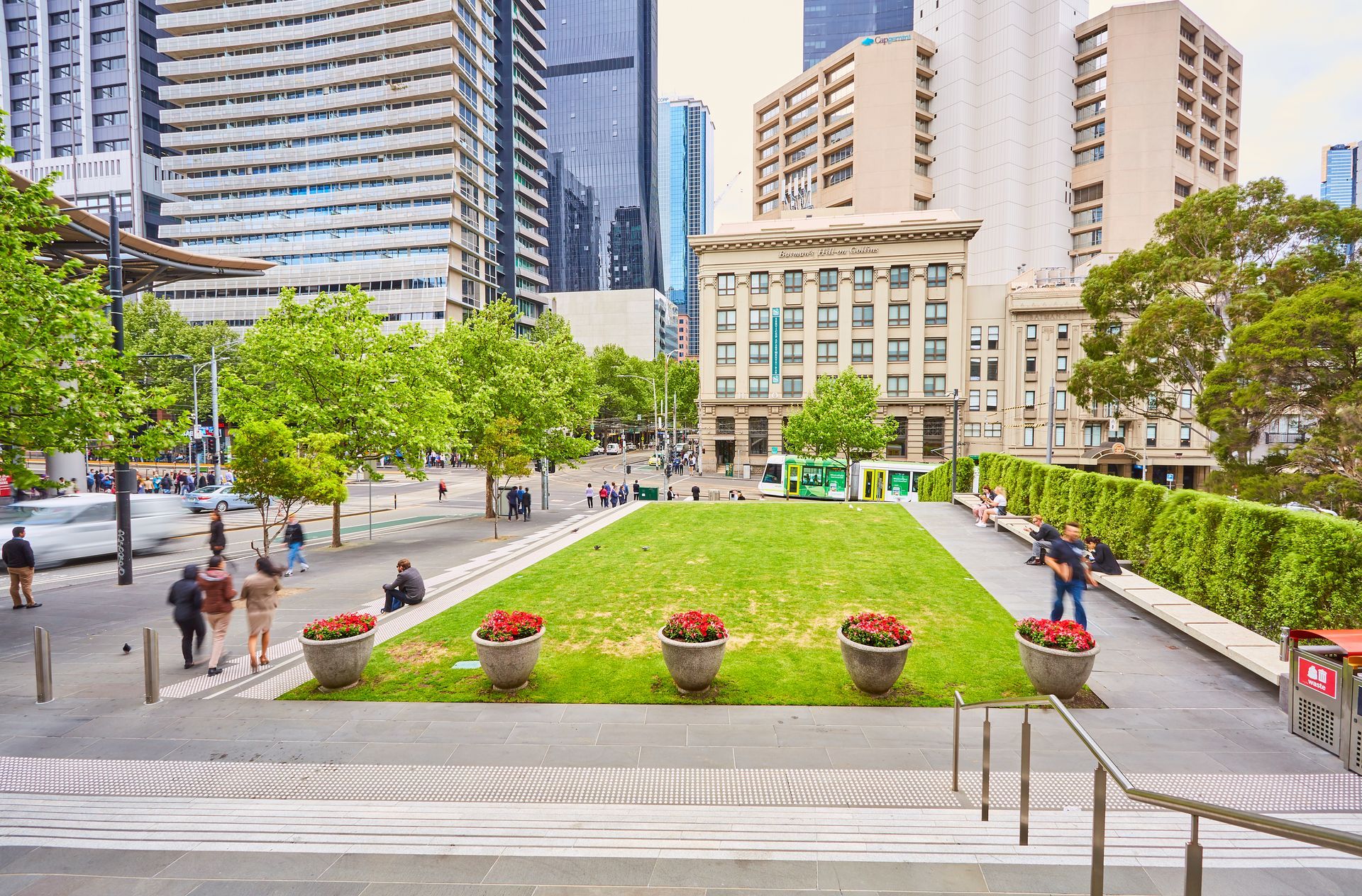 A park in the middle of a city with a lot of buildings in the background.