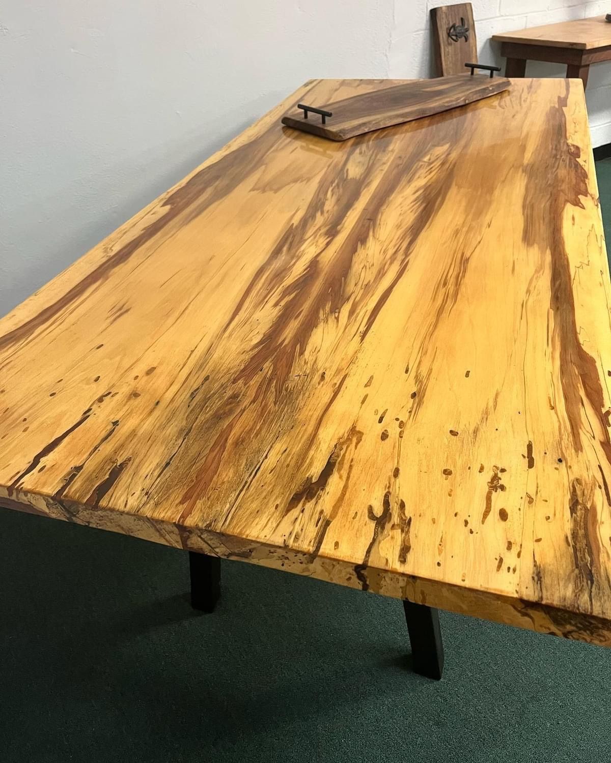 a wooden table is sitting on a concrete floor in a room .