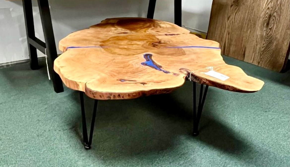 a wooden table is sitting on a concrete floor
