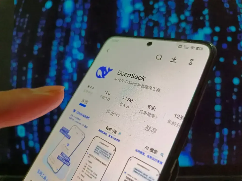 A person is holding a cell phone that says deepseek on the screen